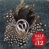http://www.tweedvixen.co.uk/feather-brooch-with-white-swirl-606-p.asp